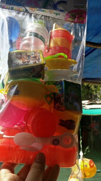 Toys on sale. Notice Amul Butter, Bisleri bottle and Taj Mahal tea